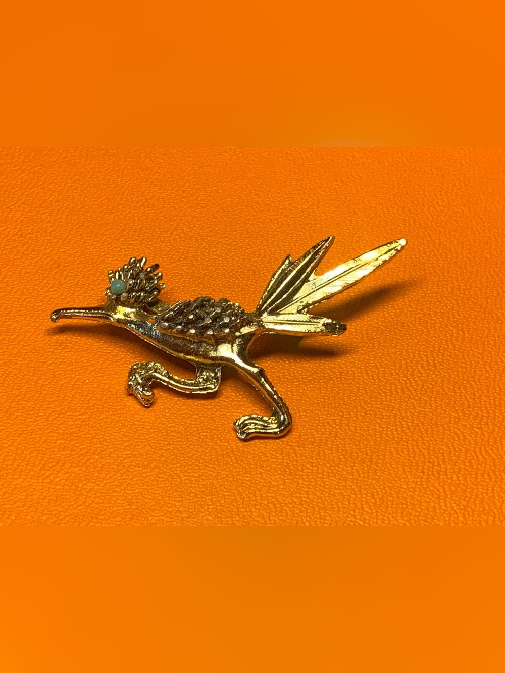 Vintage mid century gold tone road runner brooch with beaded eye.